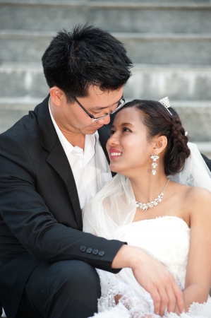 Happy Asian bride and groom on their wedding day  の写真素材