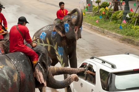 People give money for elephant in Songkran festival のeditorial素材