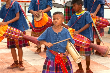group of child musicians with traditional long drum and bamboo on parades in Rocket Festival  Boon Bung Fai  in Northeast of Thailand のeditorial素材