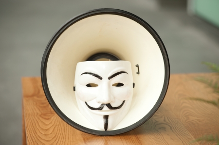 Guy Fawkes mask in megaphone on table のeditorial素材