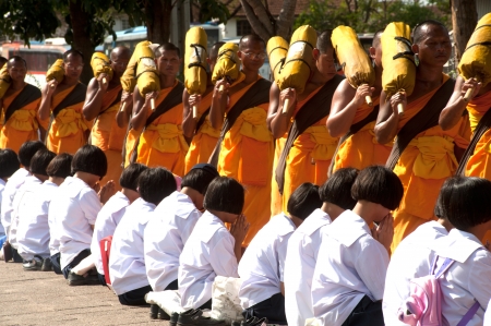 Bangkok,Thailand-January 21,2012   Row of Buddhist hike Thai monks on streets strewn with rose petals on the Thammachai hike establish the path of the great teachers on January 21,2012 in Bangkok , Thailand のeditorial素材