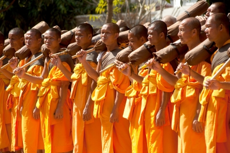 Bangkok,Thailand-January 21,2012   Row of Buddhist hike Thai monks on streets strewn with rose petals on the Thammachai hike establish the path of the great teachers on January 21,2012 in Bangkok , Thailand のeditorial素材