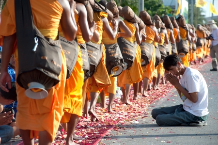 Bangkok,Thailand-January 21,2012   Row of Buddhist hike Thai monks on streets strewn with rose petals on the Thammachai hike establish the path of the great teachers on January 21,2012 in Bangkok , Thailand のeditorial素材