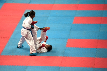 BANGKOK,THAILAND - SEPTEMBER 9   Female fighter attacks opponent with her foot in fight at Thailand Open Karate-Do Championship 2013 on Nimibutr National Indoor Stadium, September 9, 2013, Bangkok,Thailand  のeditorial素材