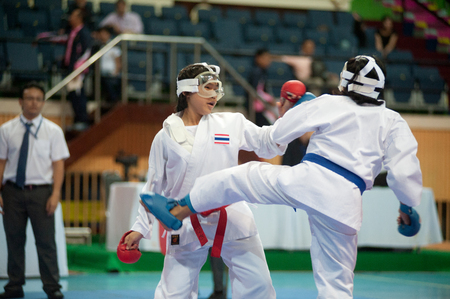 BANGKOK,THAILAND - SEPTEMBER 9   Female fighter attacks opponent with her foot in fight at Thailand Open Karate-Do Championship 2013 on Nimibutr National Indoor Stadium, September 9, 2013, Bangkok,Thailand  のeditorial素材