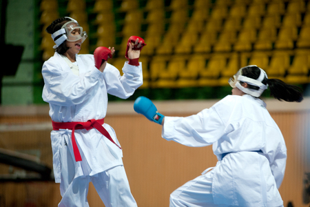 BANGKOK,THAILAND - SEPTEMBER 9 Female fighters compete in fight during of Thailand Open Karate-Do Championship 2013 on Nimibutr National Indoor Stadium, September 9, 2013, Bangkok,Thailand  のeditorial素材