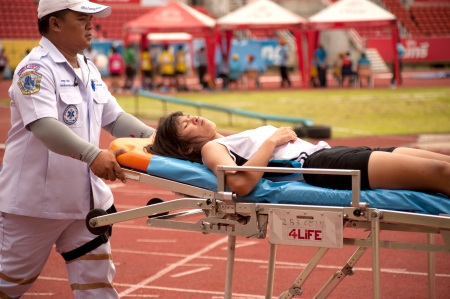 PHATUMTANI,THAILAND  SEPTEMBER,6  Groups of player injured of 100 m Hurdles in Thailand Open Athletic Championships 2013 at Thammashat University stadium on September 6,2013 in Phatumtani city ,Middle of Thailand  のeditorial素材