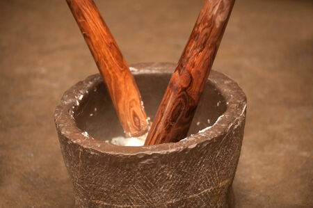  Pounding rice in a mortar 