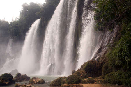 Ban Gioc Waterfall on the Quy Xuan River is located in Cao Bang Province, nears the Sino-Vietnamese border. The waterfall falls thirty meters. Located  in  Northern of Vietnam.の写真素材