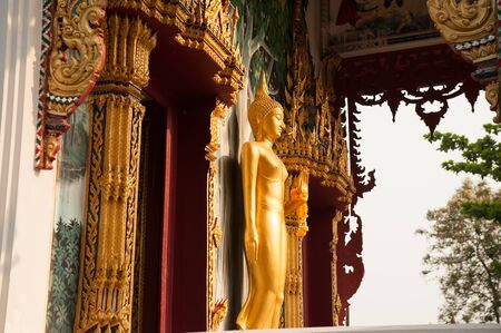 Standing Buddha front of Church at Wat Hat Siao templeThailand.