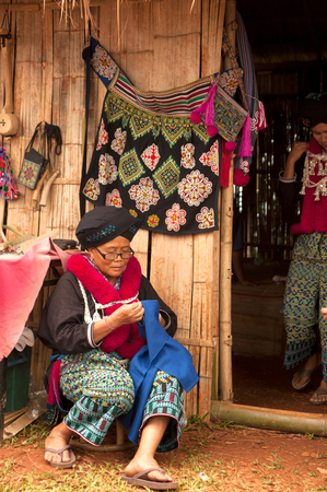 Senior Mein Hill Tribe Minority embroidery her clothes in Thailand.のeditorial素材