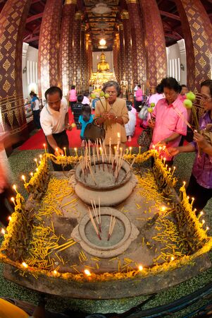 Buddhist people worship of Phra Buddha Nimitr Vichit Maramoli Sisanpeth Boromtrailokanat, Main Buddha Image at Wat Na Phrameru. The Buddha wears the Royal Attire, typical for the late period of Ayutthaya Historical Park of Thailand.                       のeditorial素材