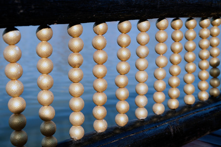 Golden golf balls hanging decorate on the rail bridge.