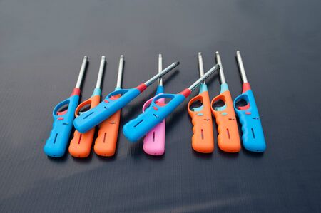 Group of colorful Gas lighter gun for gas-stove on a black background.の写真素材