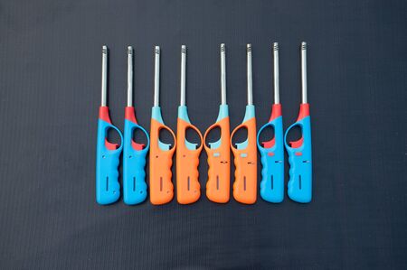 Group of colorful Gas lighter gun for gas-stove on a black background.