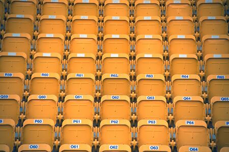 Yellow color of stadium seats in background.の写真素材
