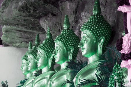 Golden Buddha statues in a cave at buddhist temple Wat Tham Khuha Sawan,Thailand.のeditorial素材