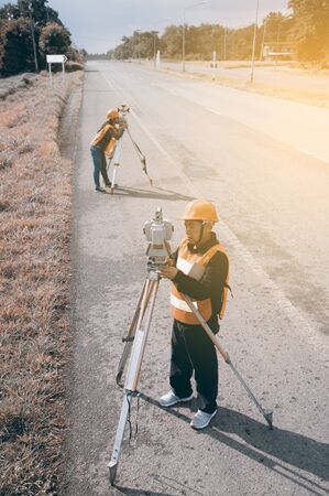 Surveyor or Engineer making measure with partner on the highway.の写真素材