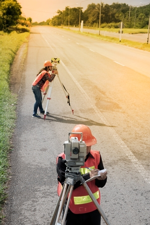 Surveyor or Engineer making measure with partner on the highway.の写真素材