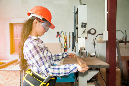 Asian pretty female carpenter using Electric Sander for wood.の写真素材