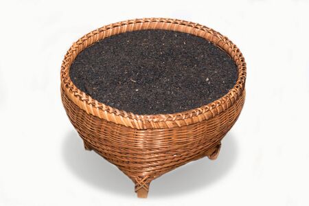 Black sesame seeds in basket on white background.の写真素材