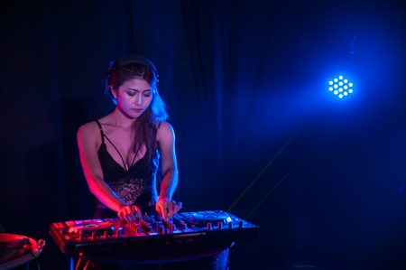 Pretty Asian female woman DJ playing music for dance.の写真素材