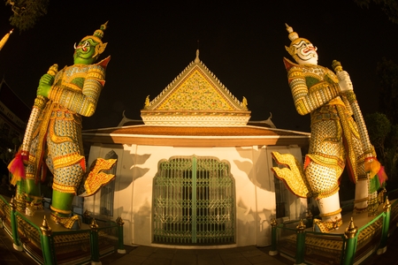 Night scene of Thai Giant guardian at front entrance of the -Ordination Hall- in Wat Arun Ratchawararam temple ,Bangkok,Thailand.のeditorial素材