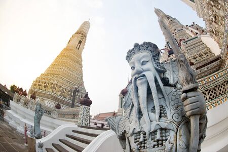 Day time of Chinese guardian statue at main Prang of Wat Arun Ratchawararam temple ,Bangkok,Thailand.の写真素材