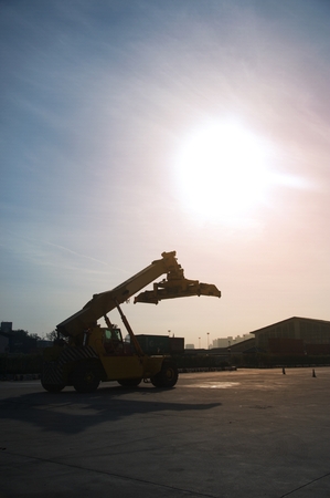 Silhouette of Forklift trucks container handlers, storage facilities to prepare the work.の写真素材