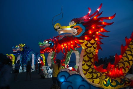Nakornsawan ,Thailand- February 18 , 2018 : Large Chinese God and Lantern standing on the ground show and decorated in twilight for Chinese New Year Celebration near river in Nakornsawan Province, Middle of Thailand.のeditorial素材