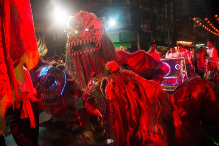 NAKORN SAWAN , THAILAND - FEBRUARY 18 , 2018 : Unidentified people fun in the Hainan tiger is dancing on parade show at night in Chinese New Year celebration on street on February 18 , 2018 in Nakorn Sawan Province , Middle of Thailand.のeditorial素材