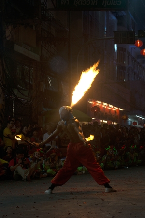 NAKORN SAWAN , THAILAND - FEBRUARY 19, 2018 : Unidentified fighter of warriors ( Aung-Gor ) the blow of fire by mouth on street in parade during Chinese New Year festival in Nakorn Sawan Province , Middle of Thailand.のeditorial素材