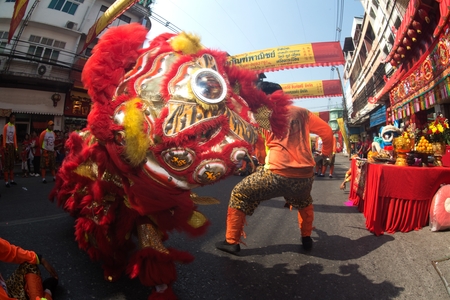 NAKORN SAWAN , THAILAND - FEBRUARY 8 , 2019 : Unidentified people show of the Hainan tiger dancing in parade and respecting the Ancestor worship table in Chinese New Year celebration on street.のeditorial素材