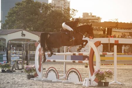 BANGKOK,THAILAND - NOVEMBER 24,2018 : Unidentified woman jockey on a horse successfully completed the jump across barrier during Princessâs Cup Thailand 2018 Competition at Sanam Pao stadium in Bangkok , Thailand.のeditorial素材
