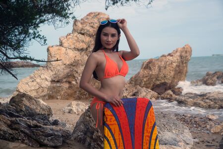 Pretty Asian woman in bikini with surf board on fun , Surfboard is water sport lessons and beach swimming activity on summer vacation.の写真素材