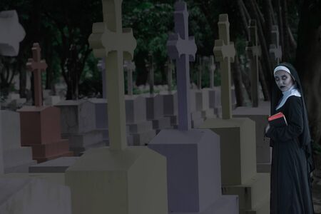 Rendering of a ghost nun or demon in the dark mysterious at the Churchyard.の写真素材