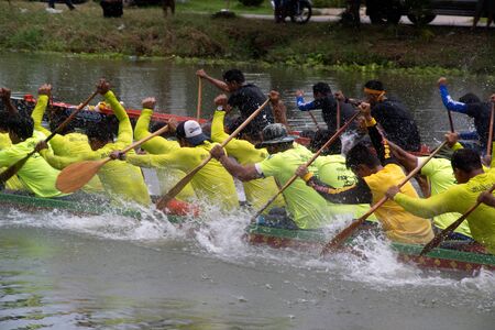 SAMUT SAKHON ,THAILAND - AUGUST 24,2019 : Unidentified rowers in native Thai long boats compete...
