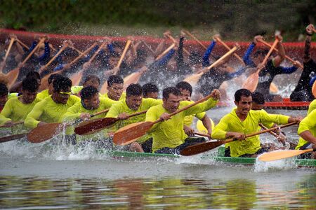 SAMUT SAKHON, THAILAND - AUGUST 24, 2019 : Unidentified rowers in native Thai long boats compete...