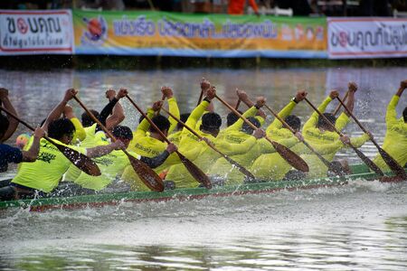 SAMUT SAKHON, THAILAND - AUGUST 24, 2019 : Unidentified rowers in native Thai long boats compete...