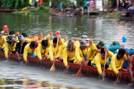 SAMUT SAKHON, THAILAND - AUGUST 24, 2019 : Unidentified rowers in native Thai long boats compete during King's Cup Native Long Boat Race Championship in Samut Sakhon Province,Middle of Thailand.   Note: Slight blurriness.のeditorial素材