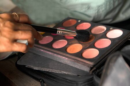 Face paint for make-up The process of choosing a color with a makeup brush for coloring, preparation...