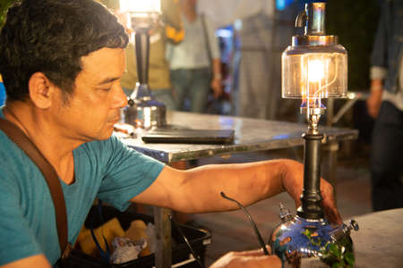 NAKORN PATHOM, THAILAND - FEBRUARY 22 , 2020 : Unidentified male is repairing the old hurricane lamp To be shown at the Hurricane lamp show 2020 event at Don Wai floating market in Nakorn Pathom Province , Middle of Thailand.のeditorial素材