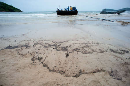 RAYONG,THAILAND-FEBRUARY 8,2013 :  Black crude oil on the beach Which is harmful to the environment...