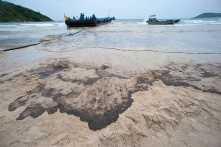 RAYONG,THAILAND-FEBRUARY 8,2013 :  Black crude oil on the beach Which is harmful to the environment at Prew beach on Samet island in Khao Laem Ya - Ko Samet National Park in Thailand.のeditorial素材