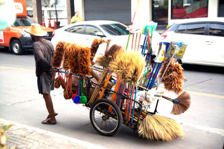 The seller dragged the rickshaw to sell household items along the road in Thailand.のeditorial素材