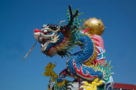 The pillars with stucco dragons wrapped around them are the art of Chinese shrines.の写真素材