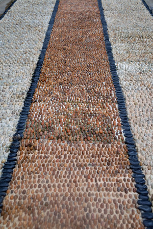 The pedestrian walkway is made from beautiful natural stone. Yellow brown Texture background for...