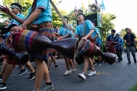 KHON KAEN,THAILAND - NOVEMBER 29 , 2019 : Unidentified The long Drum player hitting Thai drum dancing in Participants take part in the celebration of International silk  traditional and and red cross.のeditorial素材