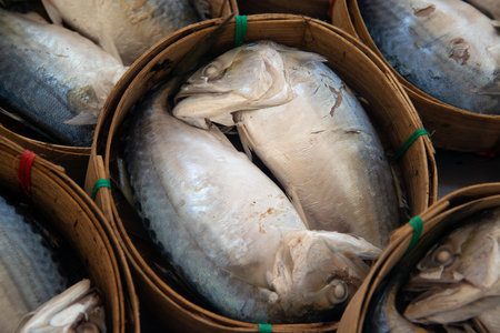 Steamed mackerel in bamboo baskets for sale at the fresh market.の写真素材