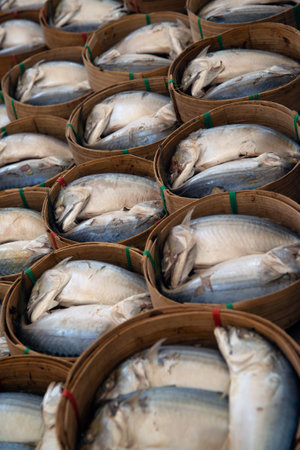 Steamed mackerel in bamboo baskets for sale at the fresh market.の写真素材